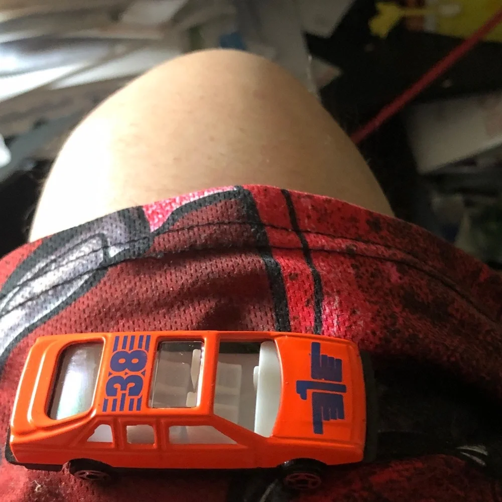 Orange Diecast Toy Race Car with Blue Number Graphics